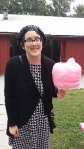 This is an image of Sara Luterman holding a giant pink blob of cotton candy.