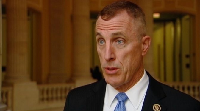 This is an image of Congressman Tim Murphy, from the shoulders up. He is wearing a black suit, white shirt, and blue tie. He is a white, middle aged man with blue eyes and a high and tight haircut.